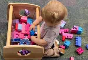 A young child exploring colorful building blocks